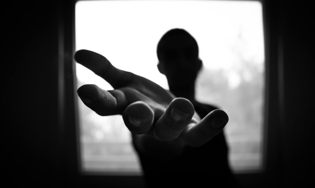 pexels-photo-167964-167964 Silhouette of a hand reaching out in a black and white contrast.