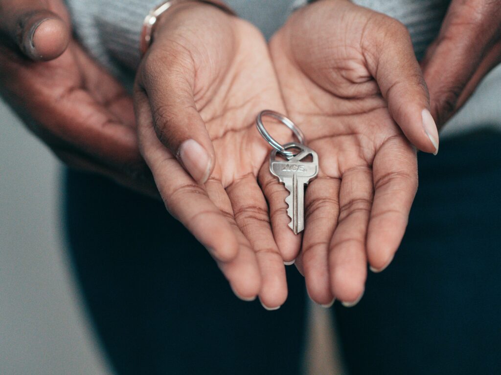 pexels-photo-7579201-7579201 Close-up of hands holding a key, symbolizing homeownership, real estate, and property investment.